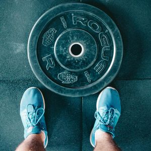Pair of sports shoes on a gym floor surface