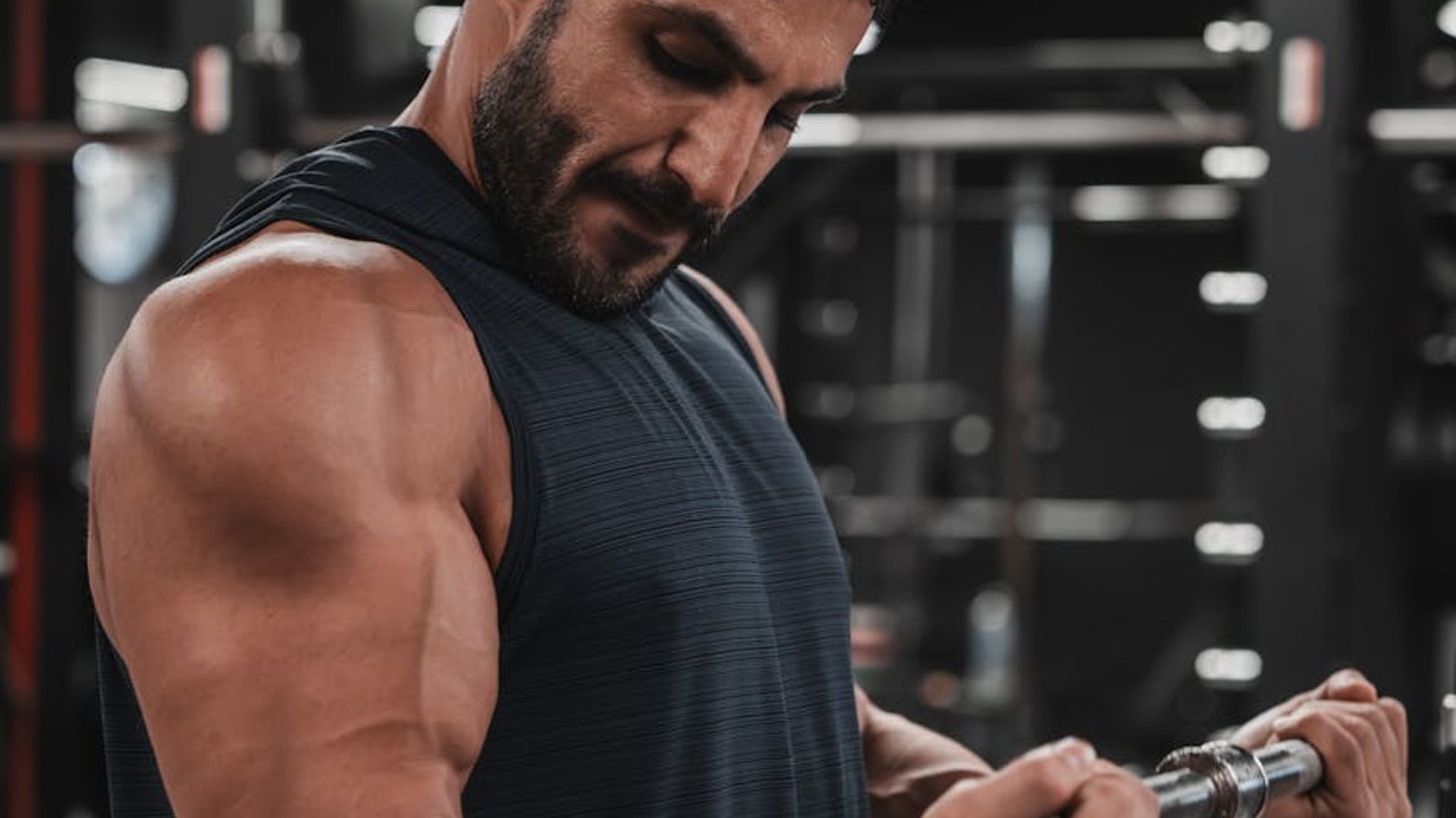 Strong athletic man focused on his training session in gym